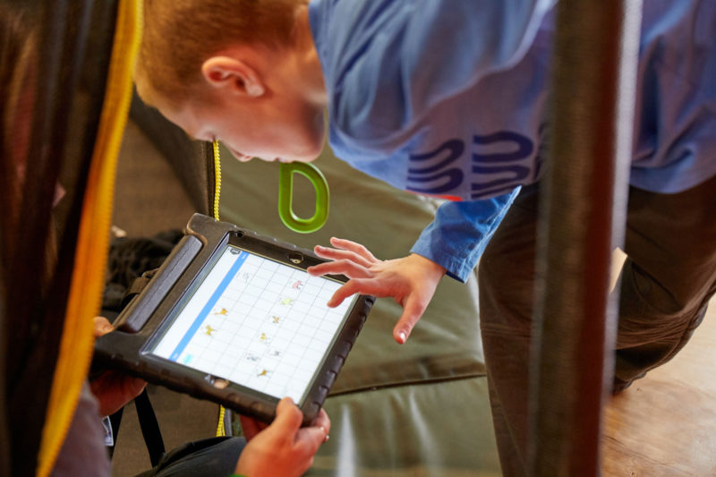 Young boy uses tablet to help communicate.